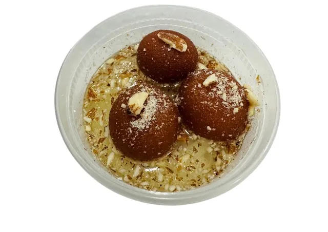 Gulab jamun in syrup with chopped nuts